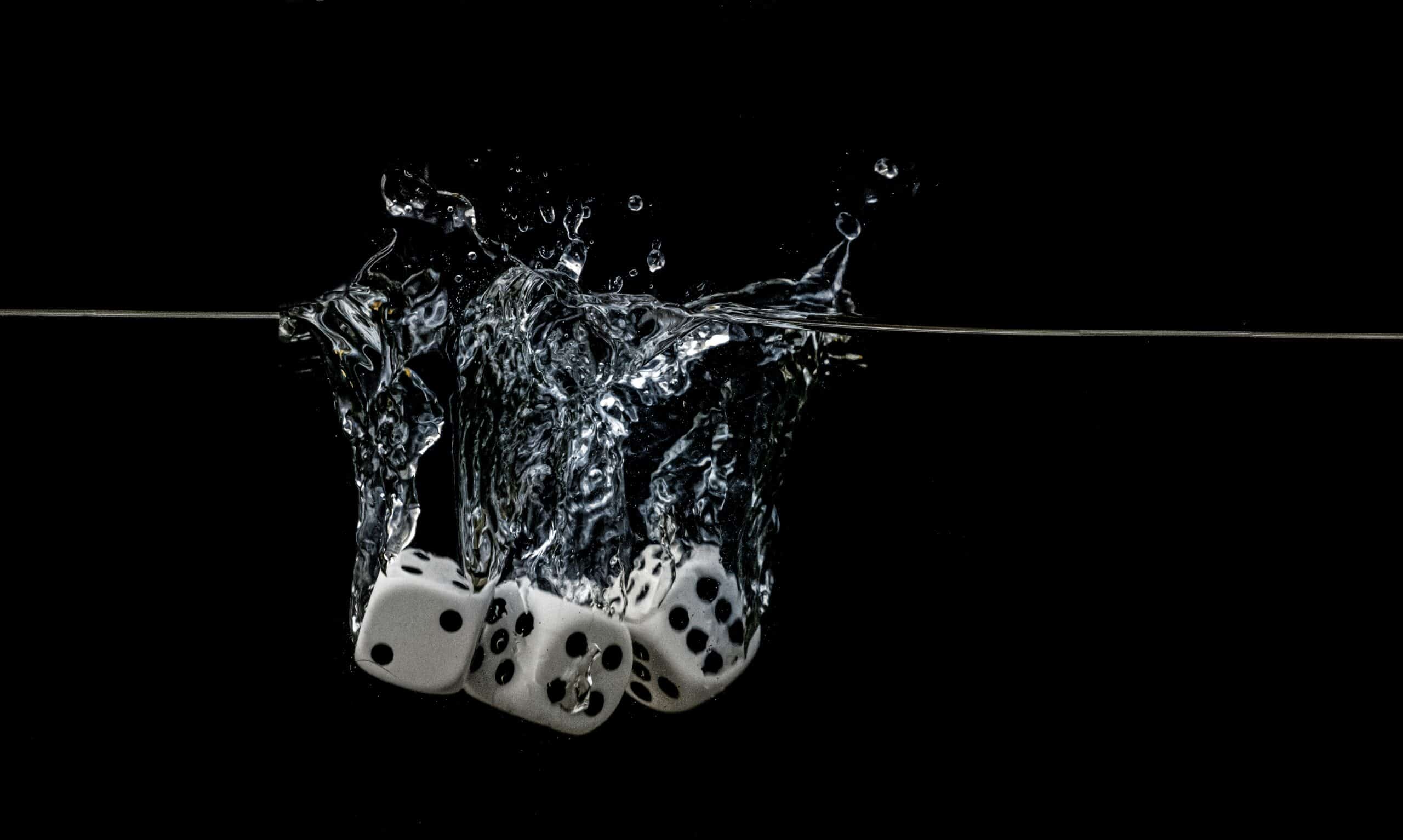 Dice falling in clear water.(Moritz Kindler/Unsplash)