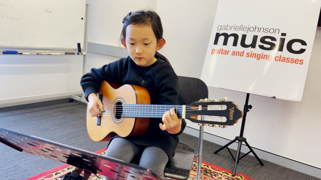 Gabrielle Johnson Music School student Raleigh on acoustic guitar