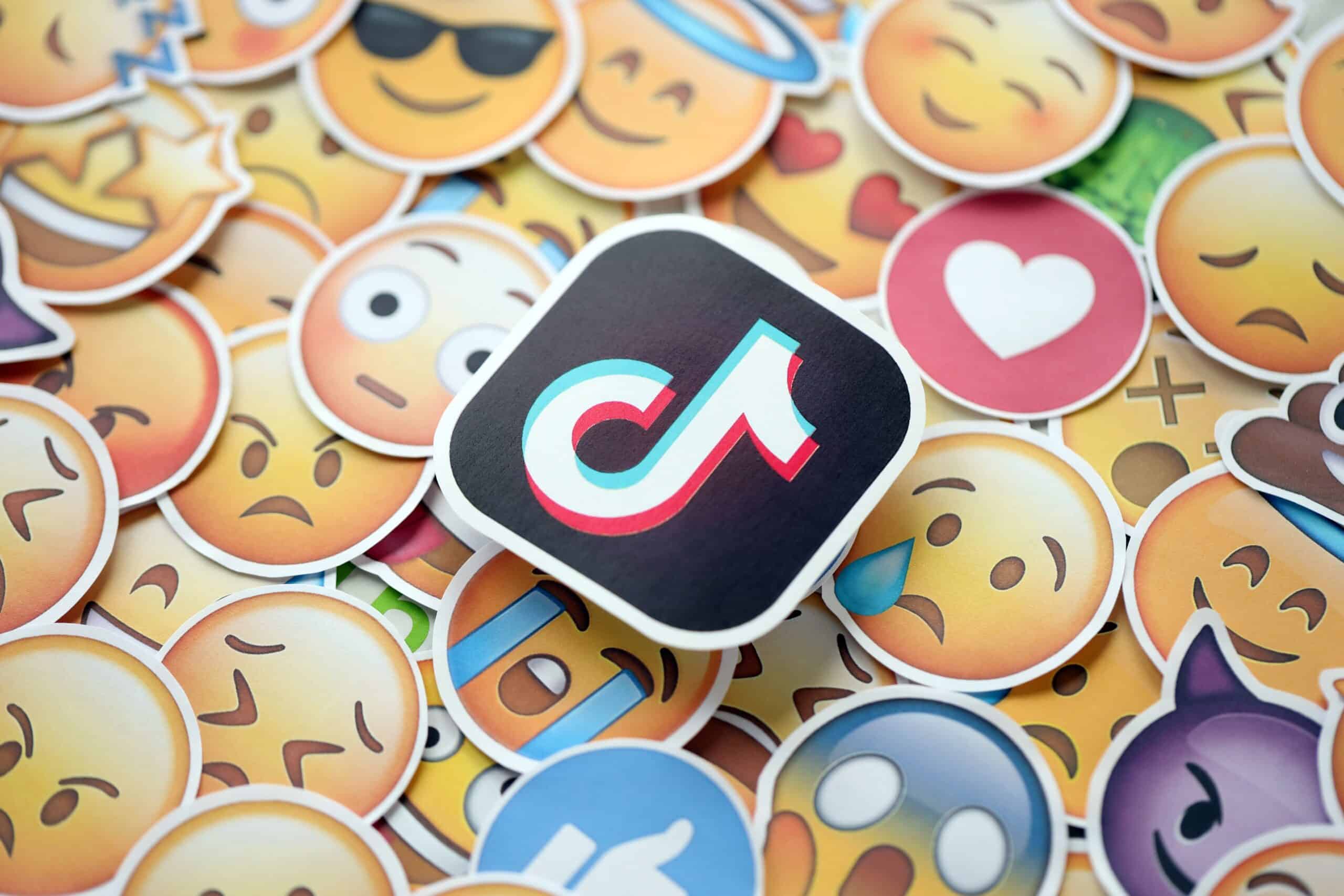 TikTok logo and large set of stickers with Emoji yellow faces (Shutterstock)